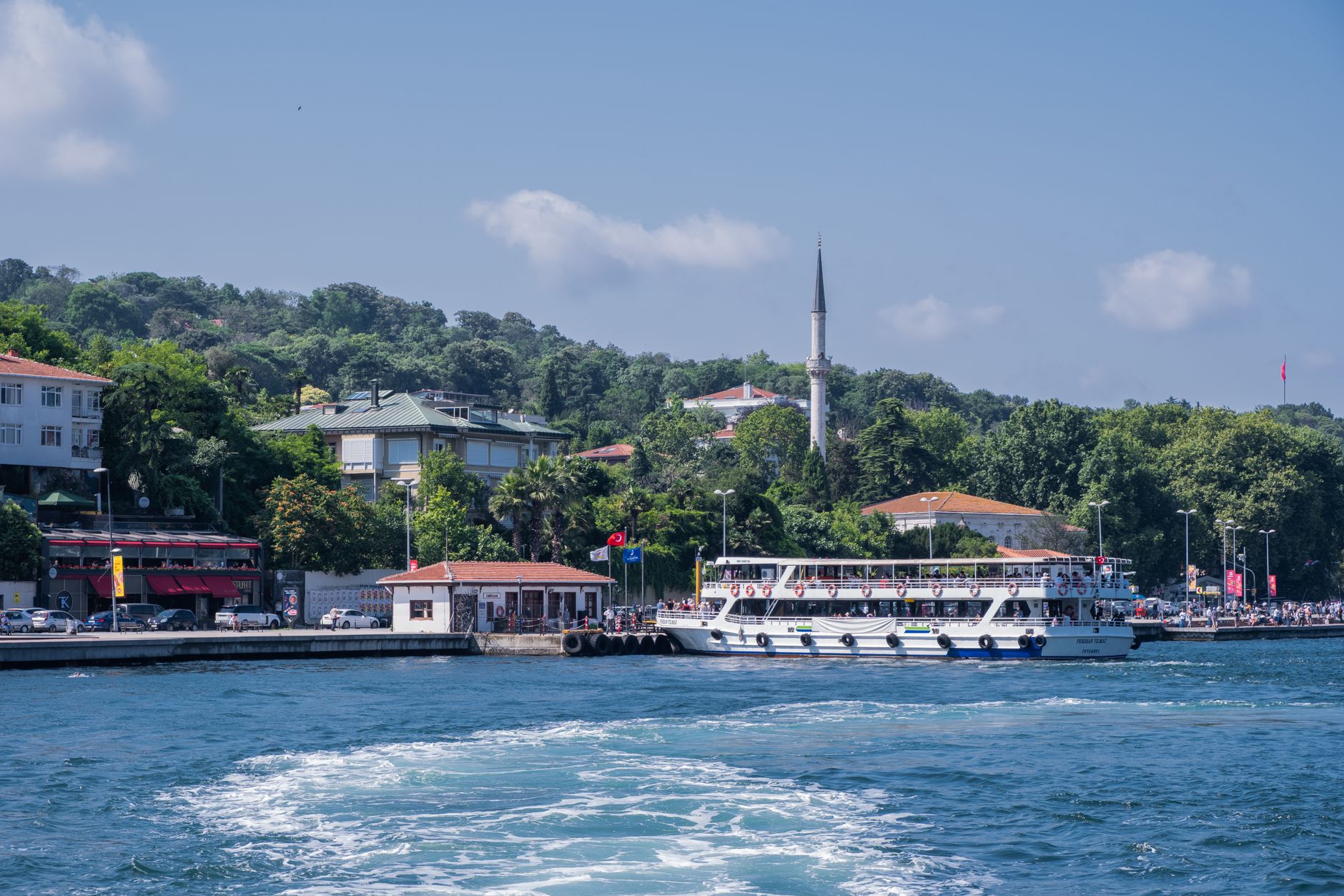 Restaurants and shops on the main street in Zekeriyaköy, Sarıyer, with forest views